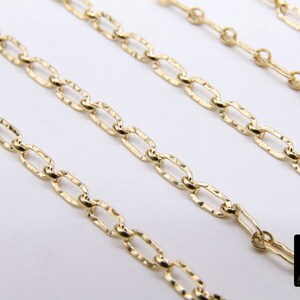 May include: Four gold chains of different lengths, all featuring a textured oval link design. The chains are arranged in a staggered pattern on a white background.