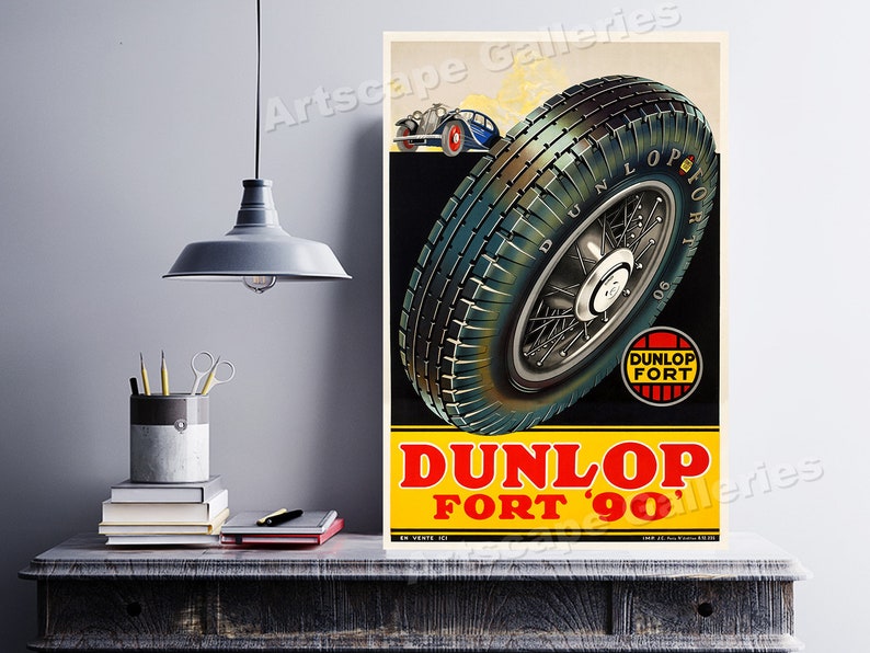 May include: Vintage poster advertising Dunlop Fort '90 tires. The poster features a close-up of a tire with a spoke wheel, a small car in the background, and the text "Dunlop Fort '90".
