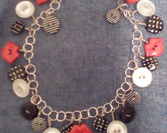 Red lip and black and white patterned button silver chain necklace