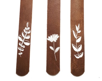 Leather bookmarks with a floral print.
