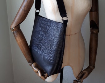 Black leather shoulder bag with crocodile print.