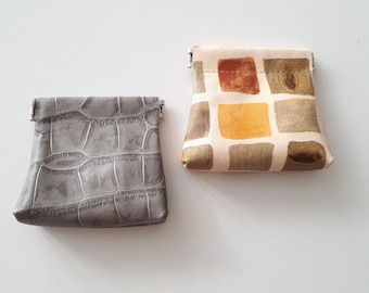 Small leather coin wallet made of unique printed leather. A leather pouch with a squeeze frame.