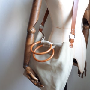 Very light yellow suede bag with round wooden handles, unique bag for a trendy woman