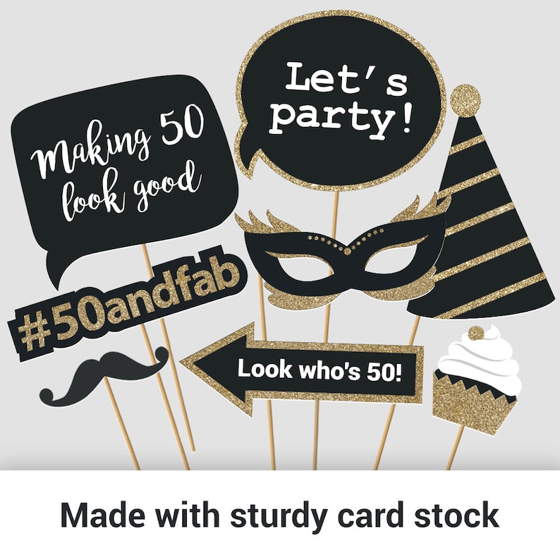 May include: Black and gold photo booth props with text that says "Let's party!" "Making 50 look good" "#50andfab" "Look who's 50!"