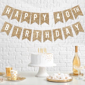 Gold glitter banner with the text "Happy 40th Birthday". A white cake with gold sprinkles sits on a white cake stand. A bottle of wine and a plate of white meringue cookies are on a table.