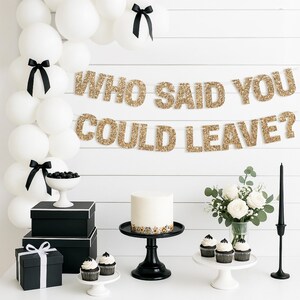 Gold glitter "WHO SAID YOU COULD LEAVE?" retirement banner for retirement party decorations.
