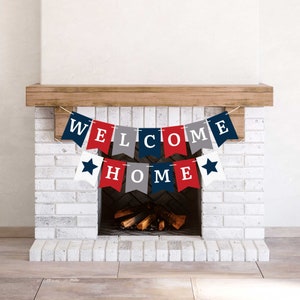 A red, white, and blue welcome home banner with white stars hanging above a fireplace.