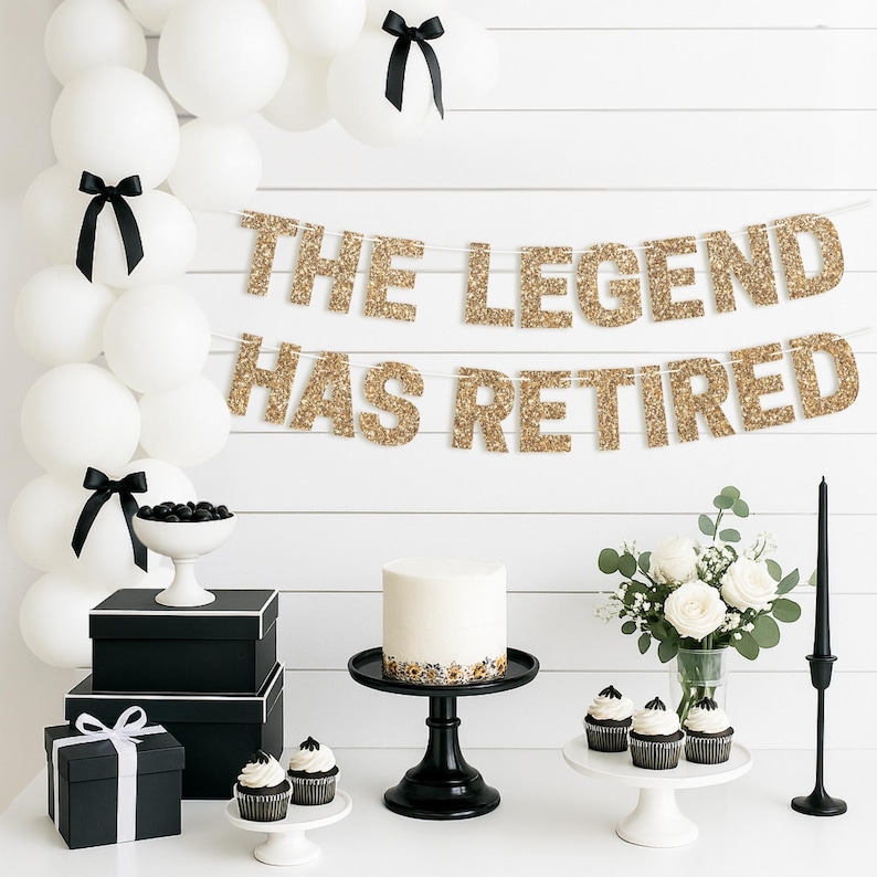 Gold glitter "The Legend Has Retired" retirement banner for retirement party decorations.