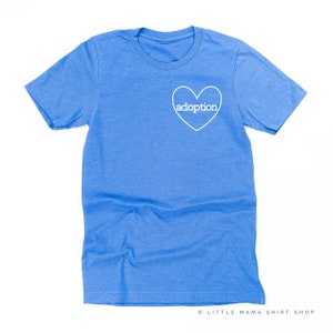 May include: A blue t-shirt with a white heart that says "adoption" inside.