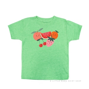 May include: A green t-shirt with a graphic of a watermelon, peach, orange, and strawberries with happy faces. The text "LITTLE MAMA SHIRT SHOP" is at the bottom of the shirt.