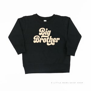 May include: Black sweatshirt with a retro-style beige "Big Brother" graphic.