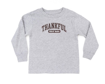 May include: A long-sleeved gray shirt with the text "THANKFUL" in a maroon arched font above "FOR MY MAMA". The shirt is made of a soft material and is suitable for children.