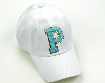 May include: White baseball cap with a large blue and gold letter "P" on the front.