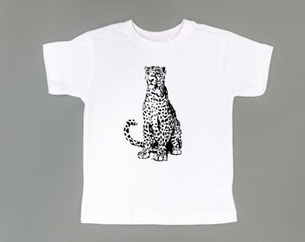 May include: White t-shirt with a black and white illustration of a leopard sitting down. The text "© LITTLE MAMA SHIRT SHOP" is at the bottom of the shirt.