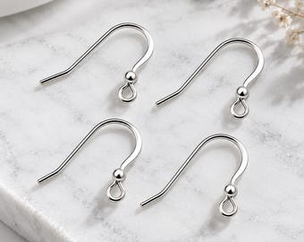 May include: Four silver-toned metal earring hooks, each featuring a curved wire design with a small decorative ball accent and a circular loop at the bottom for attaching jewelry components. These findings are polished with a smooth finish.