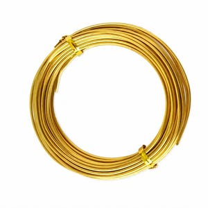 May include: A continuous coil of metallic gold-colored wire arranged in a circular shape. The wire is secured in two places by small, matching gold-colored metal fasteners that hold the circular bundle of wire together in a uniform loop.