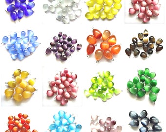 Pode incluir: Conjunto de 20 conjuntos de 20 contas de vidro olho de gato. Cada conjunto apresenta uma cor diferente, incluindo azul, branco, amarelo, rosa, roxo, laranja, marrom, verde, vermelho, azul claro e cinza.