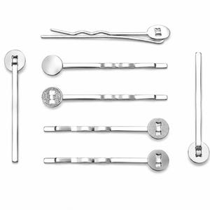 May include: An assortment of silver-coloured bobby pins and hair grips. The pins feature different designs, including straight, wavy, and circular ends. Some have textured or embellished details, suitable for various hairstyles and hair types.