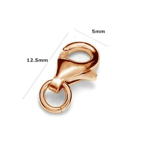 May include: A gold-toned lobster clasp with a 12.5 mm ring and a 5 mm hook. This clasp is perfect for jewelry making or repairs.