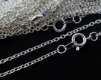 May include: A silver chain necklace with a lobster clasp and a jump ring. The chain is made of small, oval-shaped links.