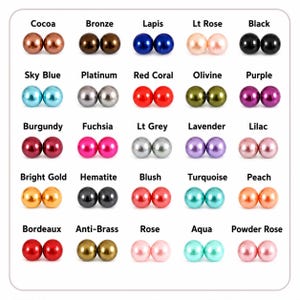 May include: A color chart featuring twenty-five pairs of round, glossy beads arranged in a grid. Each pair is labeled with its color name, including Cocoa, Bronze, Lapis, Lt Rose, Black, Sky Blue, Platinum, Red Coral, Olivine, Purple, Burgundy, Fuchsia, Lt Grey, Lavender, Lilac, Bright Gold, Hematite, Blush, Turquoise, Peach, Bordeaux, Anti-Brass, Rose, Aqua, and Powder Rose.