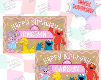 May include: A digital birthday banner design featuring Sesame Street characters Elmo, Big Bird, Cookie Monster, and Abby Cadabby. The tan background has a pink border, white text reading Happy Birthday, and a pink name plate with the name Carsyn.