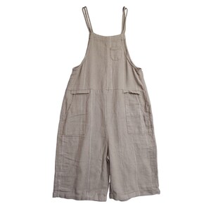 May include: A pair of beige linen overalls with thin white stripes. The overalls have two large pockets on the front and a smaller pocket on the chest.