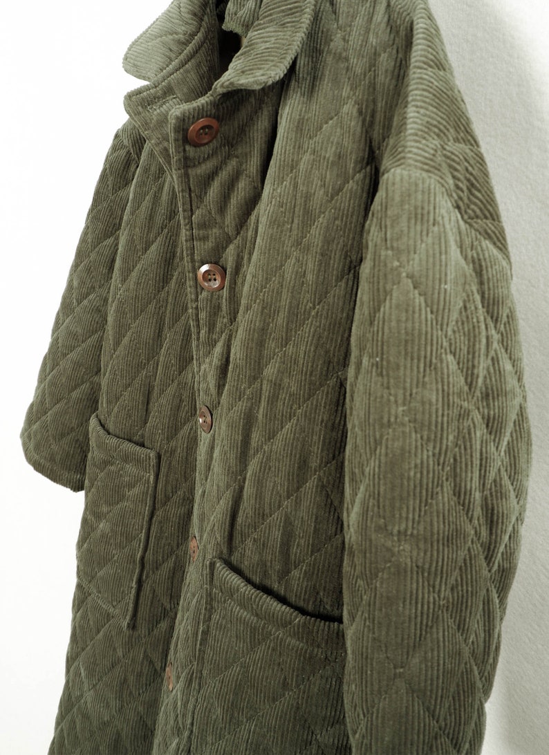 May include: A quilted green corduroy jacket with a button-up front and two patch pockets.