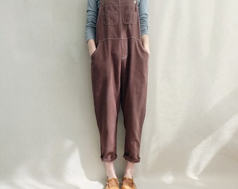 May include: A brown overall with a button closure and two large pockets. The overall has a relaxed fit and is made of a soft, comfortable fabric.