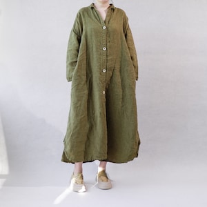 May include: A long, green linen shirt dress with a button-up front and long sleeves. The dress has a relaxed fit and a slightly A-line silhouette.