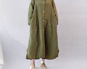 May include: A long, green linen shirt dress with a button-up front and long sleeves. The dress has a relaxed fit and a slightly A-line silhouette.