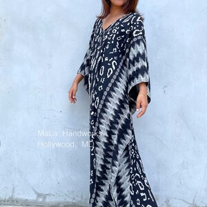 May include: A black and white maxi dress with a geometric pattern. The dress has a V-neckline and 3/4 sleeves. The dress is flowing and has a relaxed fit. The dress is made of a soft, comfortable fabric.  "MaLa Handworks Hollywood, MD"