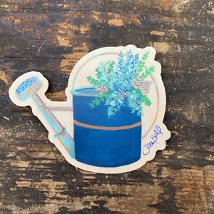 Sticker arrosoir vintage avec pommes de pin et feuilles de genièvre