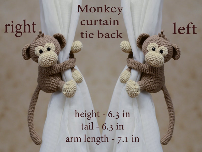 Two brown crocheted monkey curtain tie backs. Each monkey is holding onto a white curtain with its arms and has a long tail. The monkeys are 6.3 inches tall, 6.3 inches from head to tail, and have arms that are 7.1 inches long.