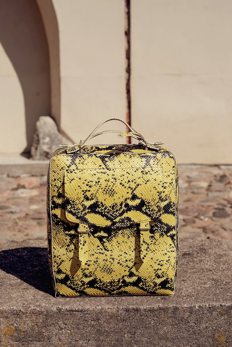Leather backpack in yellow and black snake skin pattern imitation with adjustable straps Spacious structured animal print rucksack \u201eLupin\u201c