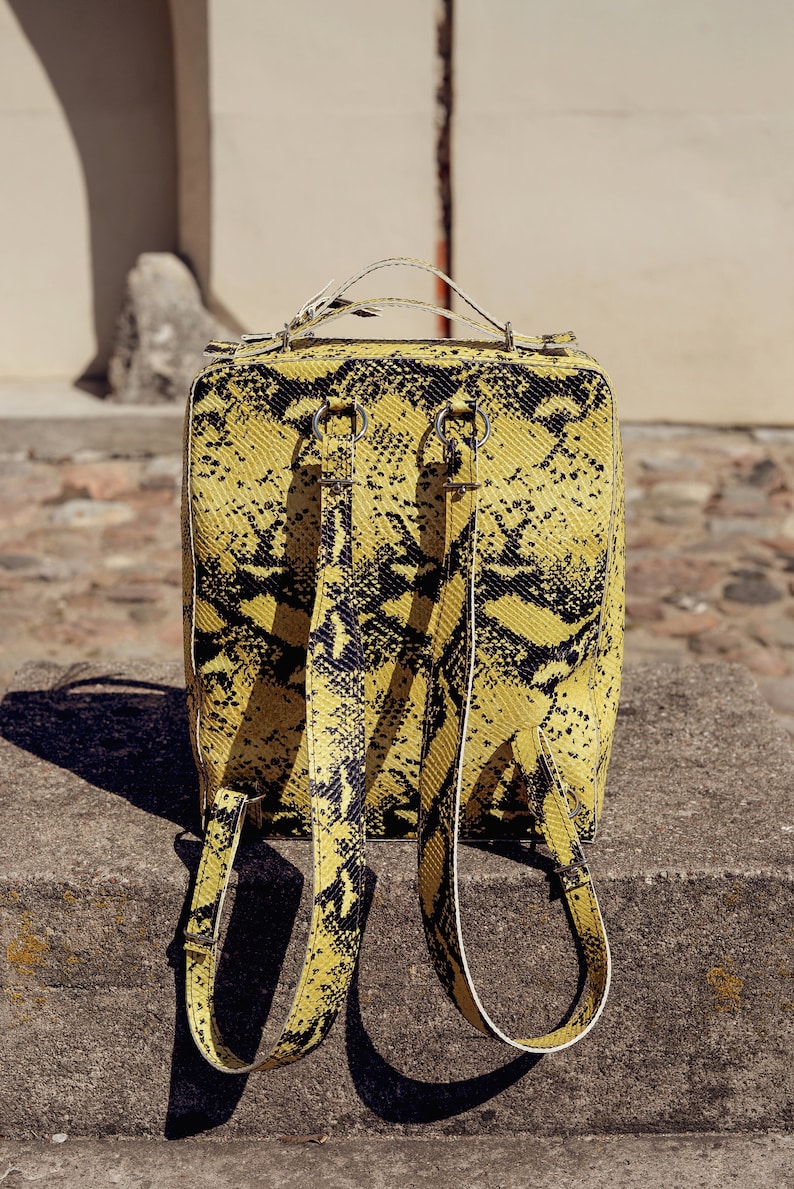 Leather backpack in yellow and black snake skin pattern imitation with adjustable straps Spacious structured animal print rucksack \u201eLupin\u201c