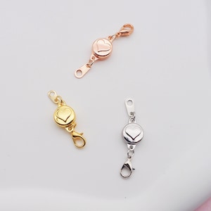 May include: Three magnetic clasps for jewelry making. The clasps are round with a heart design and come in gold, silver, and rose gold.