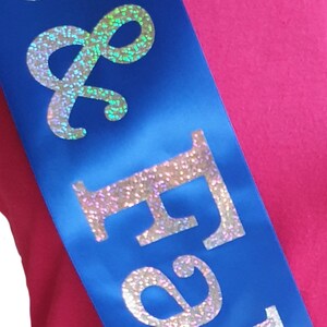 May include: A blue satin sash with the words "& Forever" in silver glitter lettering.