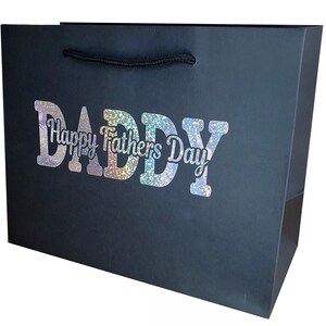 May include: Black gift bag with a holographic silver glitter design that says "Daddy Happy Fathers Day".
