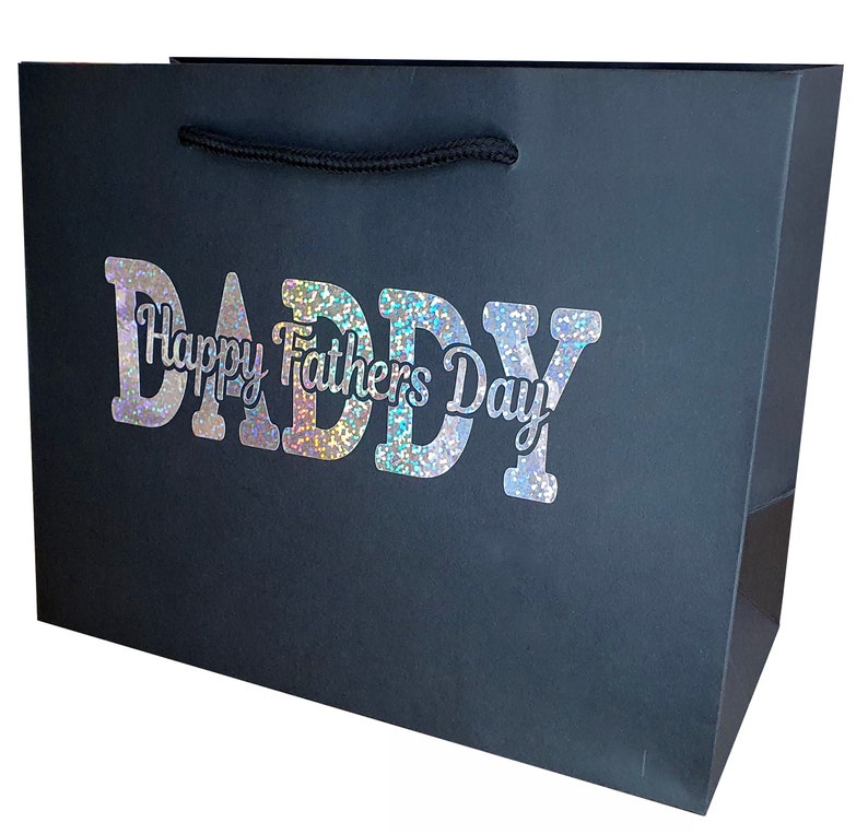 May include: Black gift bag with a holographic silver glitter design that says "Daddy Happy Fathers Day".