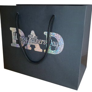 May include: Black gift bag with a silver glitter design that says "Happy Father's Day DAD".