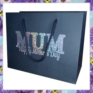 May include: Black gift bag with a silver glitter design that says "MUM Happy Mother's Day".