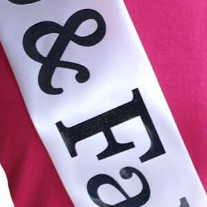 May include: White satin sash with black lettering that reads "& Forever".