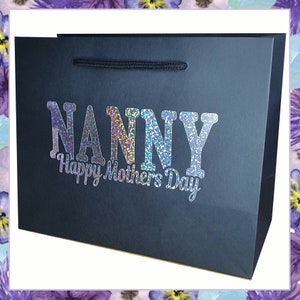 May include: Black gift bag with a silver glitter design that says "NANNY Happy Mother's Day".