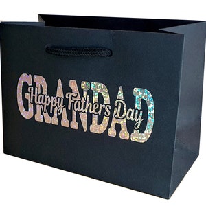 May include: Black gift bag with a holographic silver glitter design that says "Grandad Happy Father's Day".