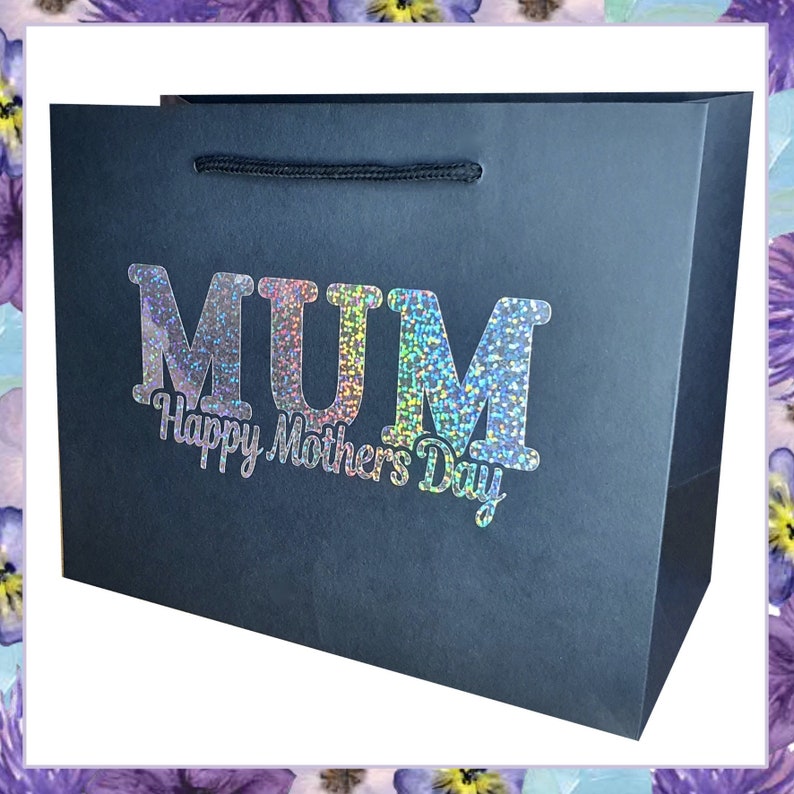 May include: A black gift bag with a holographic silver glitter design that says "MUM Happy Mother's Day".