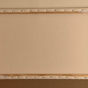 May include: A blank canvas stretched over a wooden frame, ready for painting. The canvas is white and the frame is made of natural wood.