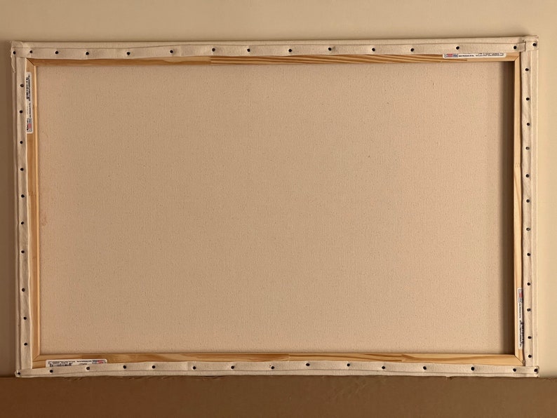 May include: A blank canvas stretched over a wooden frame, ready for painting. The canvas is white and the frame is made of natural wood.