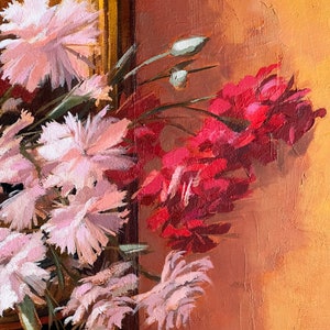 May include: A painting of a bouquet of pink and red flowers against a warm orange background. The flowers are arranged in a vase, and the painting is framed in gold.