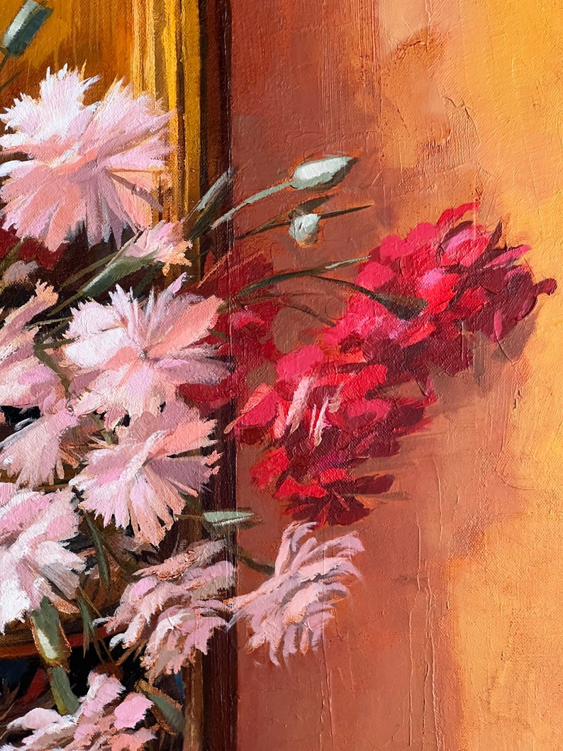 May include: A painting of a bouquet of pink and red flowers against a warm orange background. The flowers are arranged in a vase, and the painting is framed in gold.